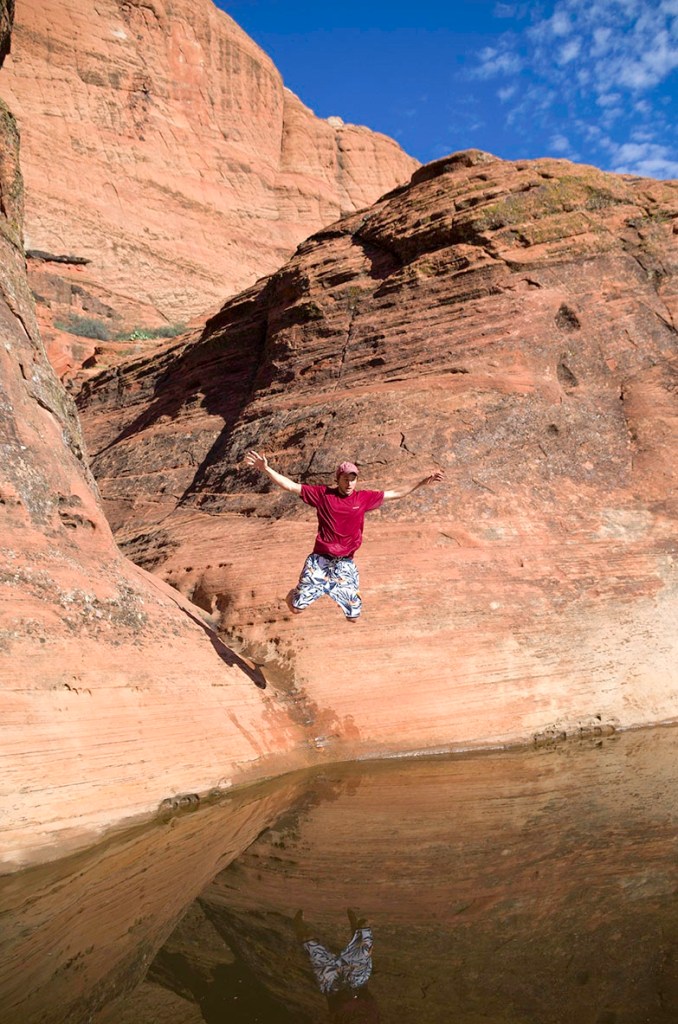 Yours truly jumping into a watering hole in Snow Canyon, Utah. Photo by Kerrick James. 